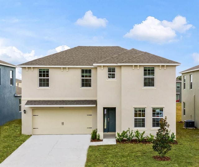 view of front of home featuring cooling unit, a front lawn, and a garage