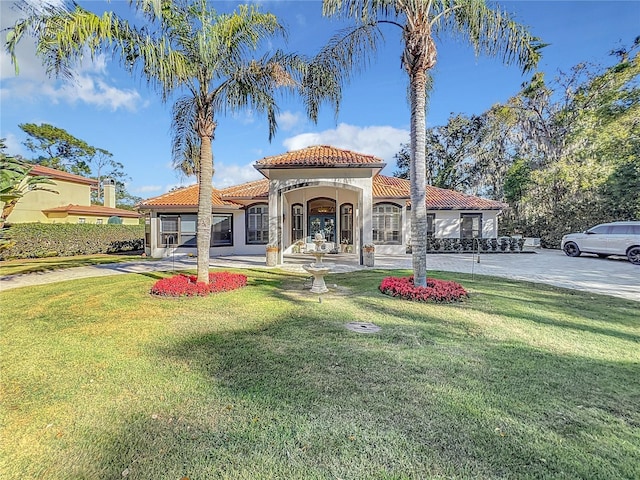 mediterranean / spanish-style house with a front lawn