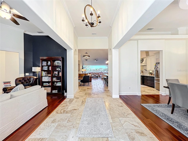 hallway featuring wood-type flooring, a chandelier, and ornamental molding