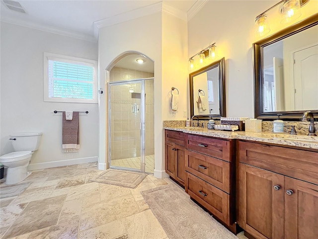 bathroom with vanity, toilet, a shower with door, and crown molding