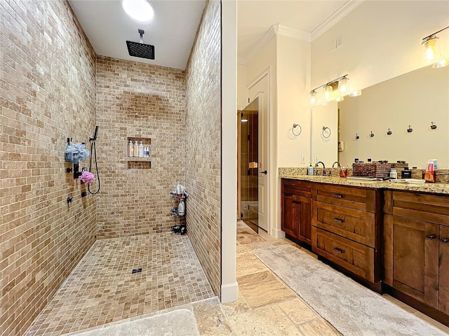 bathroom with crown molding, vanity, and tiled shower