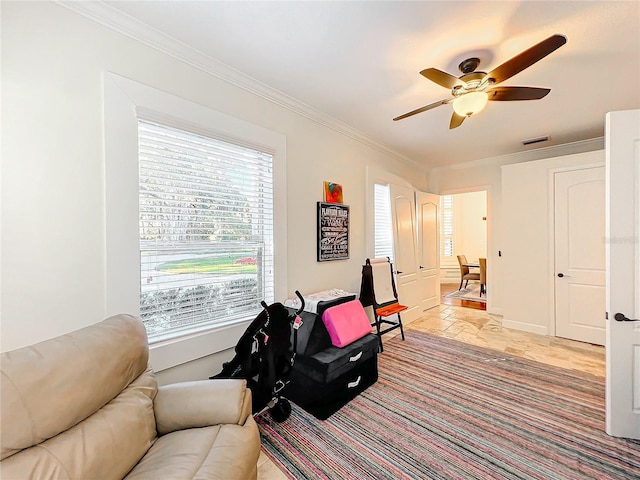 living area featuring ceiling fan and ornamental molding