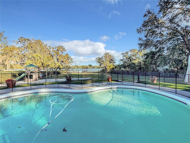 view of swimming pool with a playground