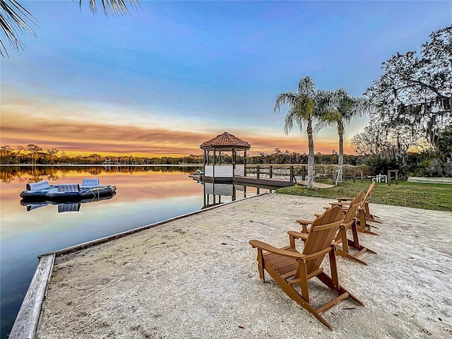 view of property's community featuring a gazebo, a water view, and a dock