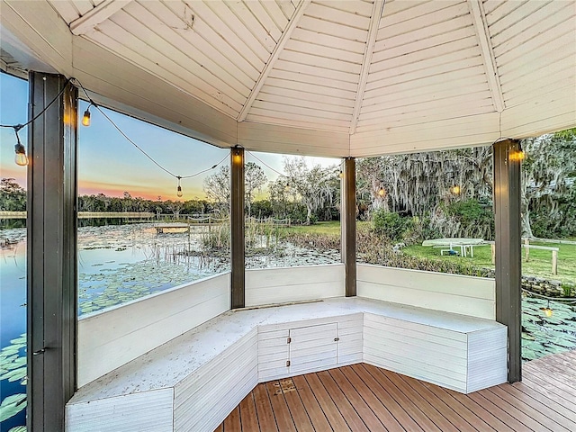 exterior space with lofted ceiling, a water view, and wood ceiling