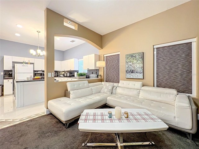 living room featuring light tile patterned floors and a notable chandelier