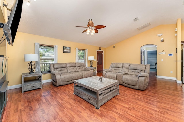 living room with wood-type flooring, ceiling fan, and vaulted ceiling