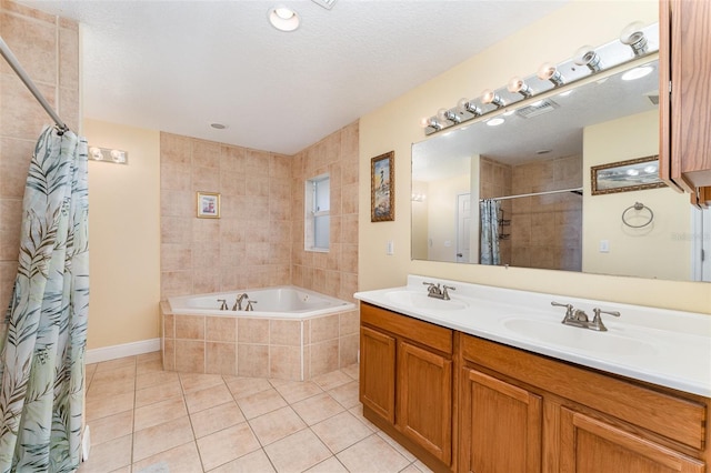 bathroom with a textured ceiling, vanity, and tile patterned floors