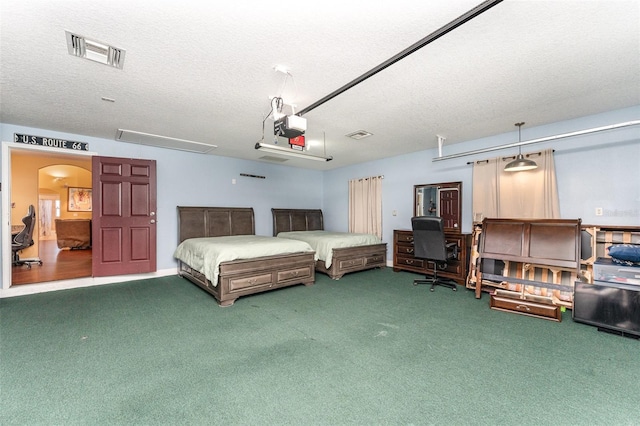 bedroom featuring a textured ceiling and carpet