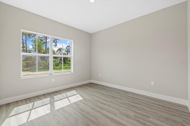 unfurnished room with light wood-type flooring