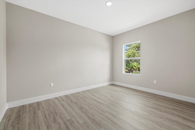 unfurnished room with light hardwood / wood-style floors