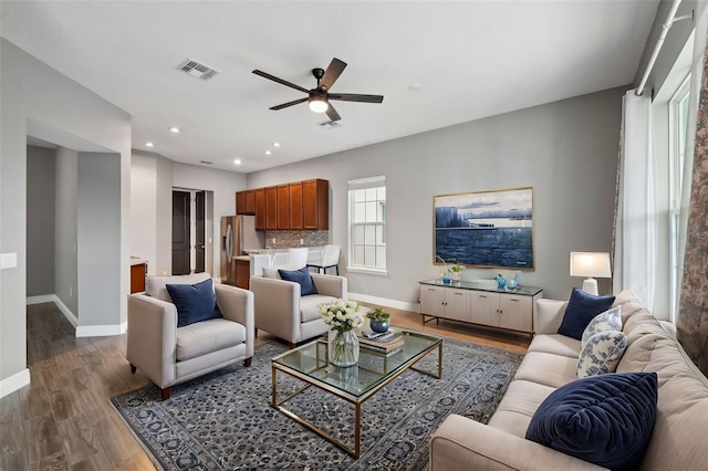 living room with ceiling fan and dark hardwood / wood-style floors