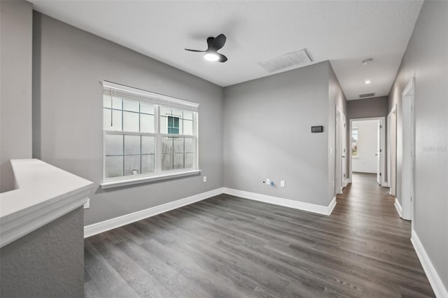 unfurnished dining area with ceiling fan and dark hardwood / wood-style floors