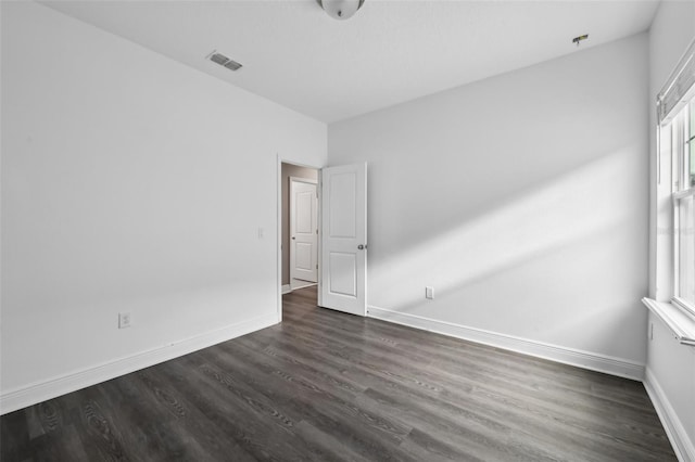 spare room featuring dark wood-type flooring