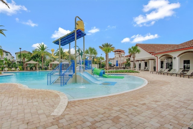 view of swimming pool featuring a patio area and a water slide