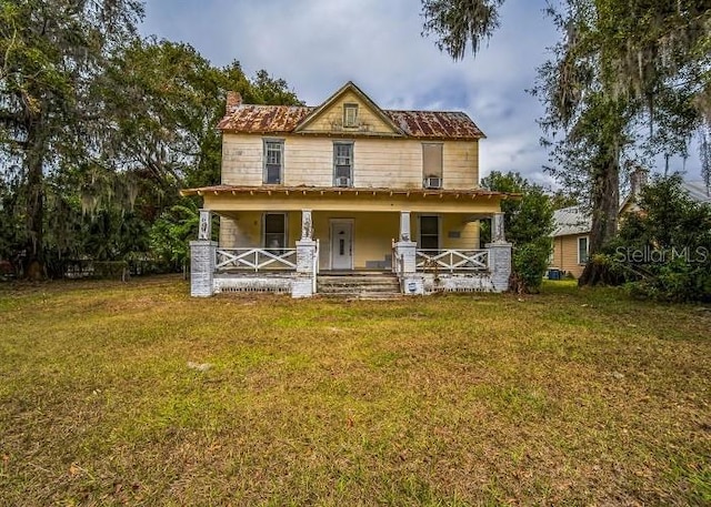 country-style home with covered porch and a front yard