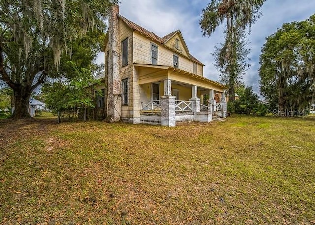 exterior space featuring a lawn and a porch