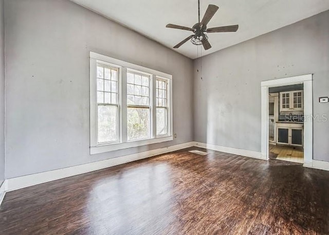 unfurnished room with ceiling fan and wood-type flooring