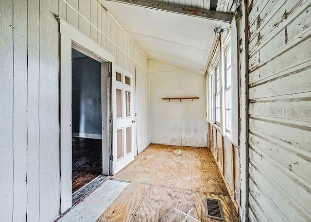 hallway featuring lofted ceiling with beams