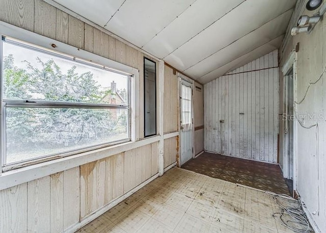 unfurnished sunroom featuring lofted ceiling