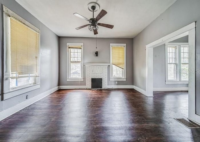 unfurnished living room with french doors, ceiling fan, a fireplace, and dark hardwood / wood-style floors