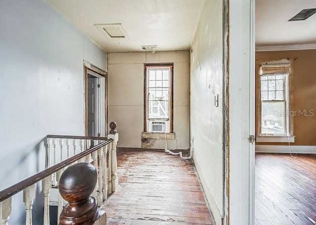 hallway with hardwood / wood-style floors, plenty of natural light, and cooling unit