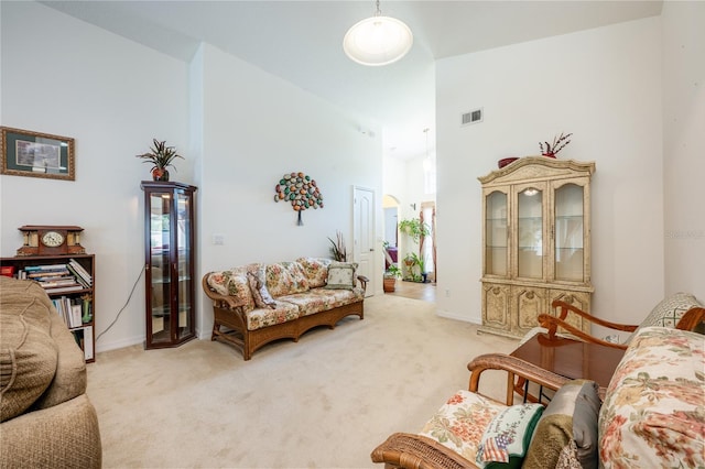 carpeted living room featuring high vaulted ceiling