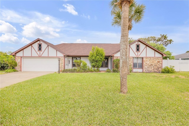 tudor home with a garage and a front yard