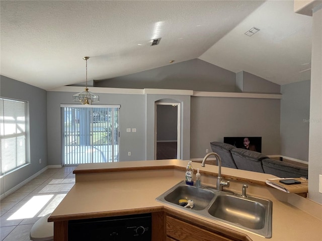 kitchen featuring dishwasher, sink, an inviting chandelier, lofted ceiling, and light tile patterned flooring