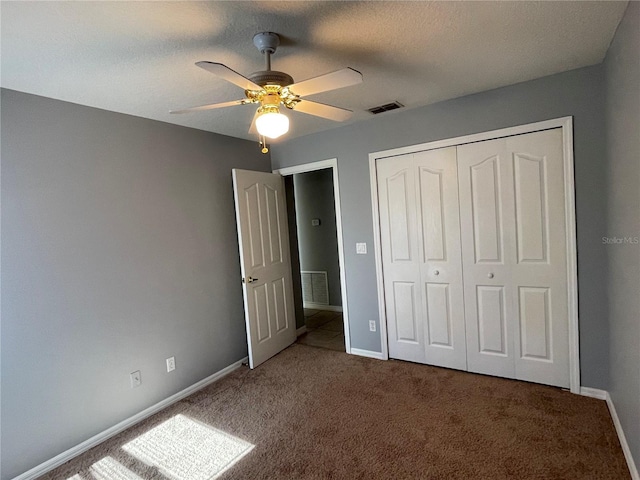 unfurnished bedroom with ceiling fan, a closet, and carpet