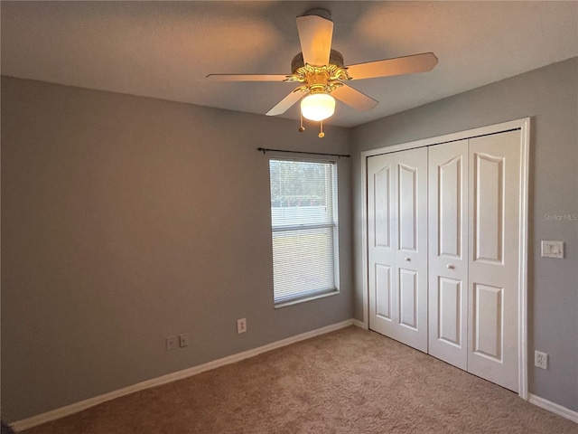 unfurnished bedroom with a closet, ceiling fan, and light colored carpet