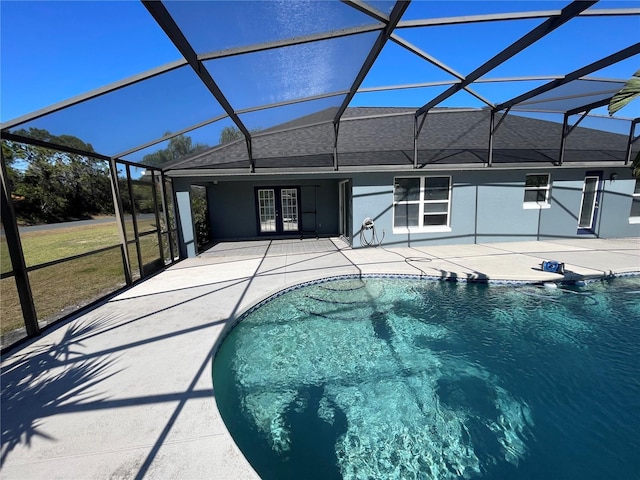 view of pool featuring glass enclosure, a patio area, and french doors