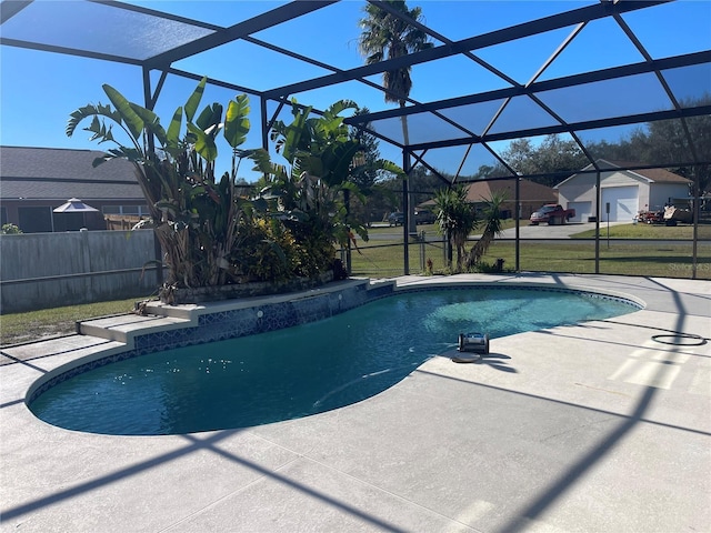 view of swimming pool featuring a lanai, a patio area, and a yard