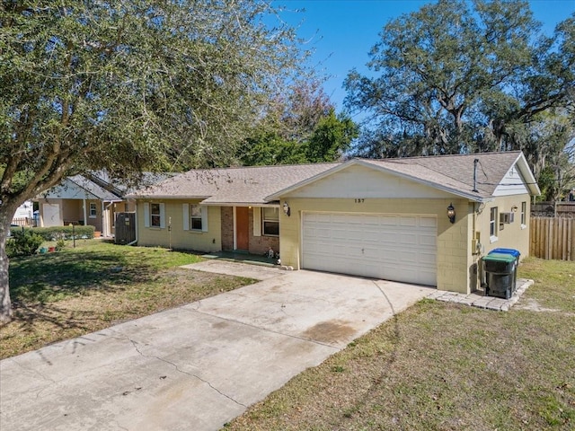 ranch-style home with a garage and a front lawn