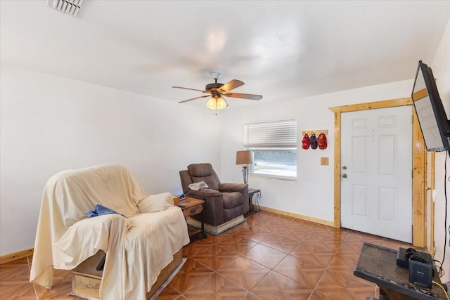 sitting room with parquet floors and ceiling fan