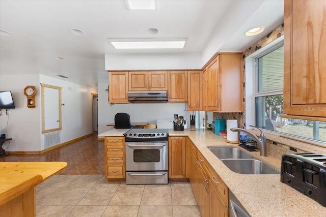 kitchen with light stone countertops, stainless steel electric range oven, sink, and light tile patterned floors