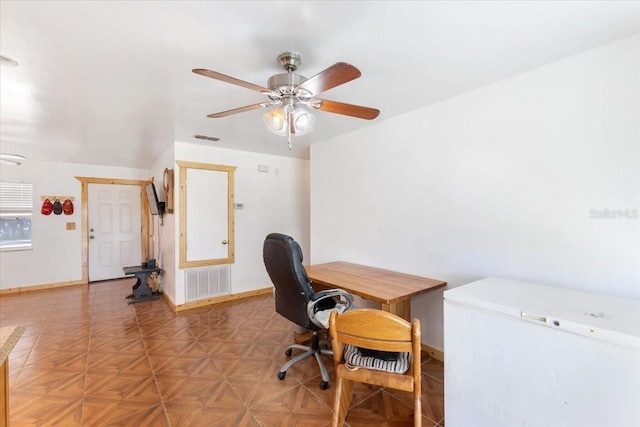 office space featuring ceiling fan and parquet floors