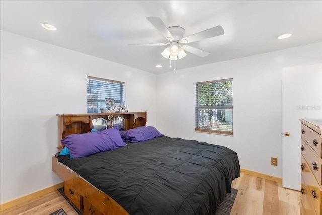 bedroom with light wood-type flooring and ceiling fan