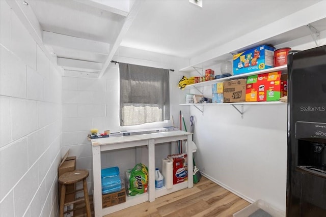 clothes washing area with wood-type flooring