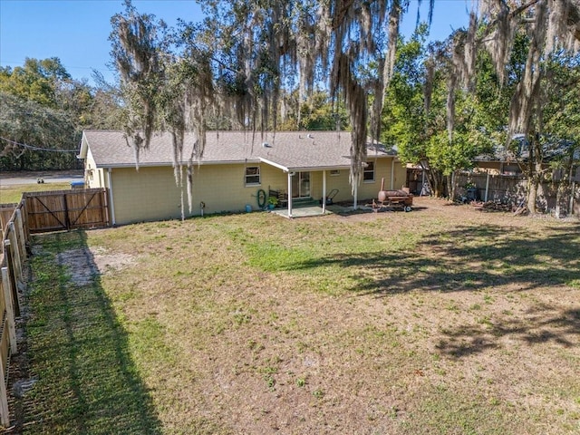 rear view of house featuring a lawn