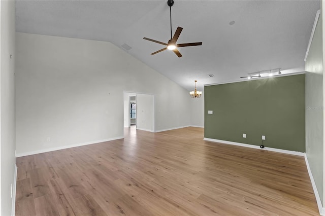 unfurnished living room featuring ceiling fan with notable chandelier, light hardwood / wood-style flooring, and high vaulted ceiling