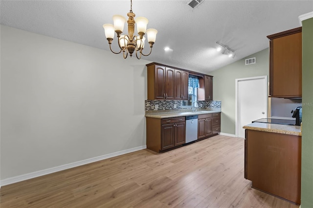 kitchen featuring pendant lighting, dishwasher, range, tasteful backsplash, and vaulted ceiling