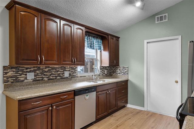 kitchen with dishwasher, lofted ceiling, sink, decorative backsplash, and light hardwood / wood-style flooring