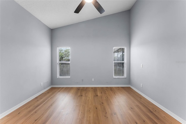 unfurnished room featuring ceiling fan, lofted ceiling, and light hardwood / wood-style flooring