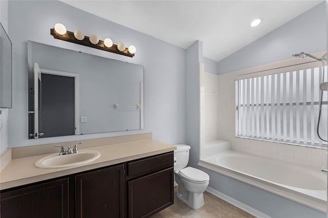 bathroom with tile patterned floors, lofted ceiling, a tub to relax in, toilet, and vanity