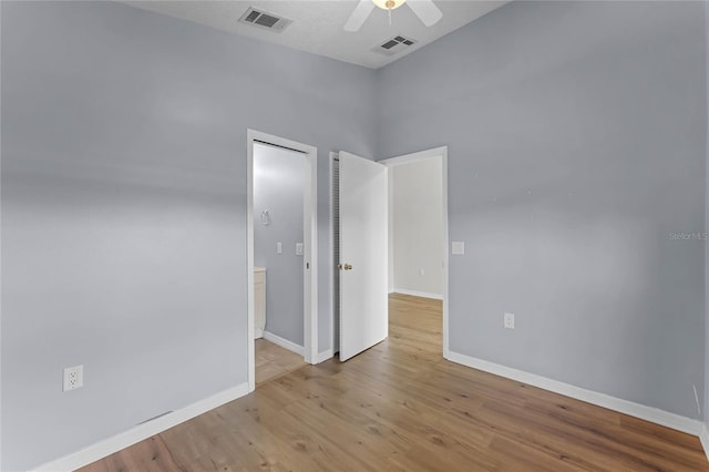 spare room featuring ceiling fan and light hardwood / wood-style flooring