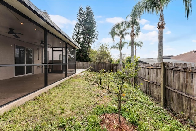 view of yard featuring ceiling fan and a patio