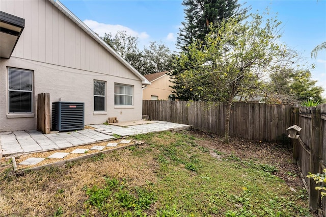 view of yard with cooling unit and a patio area