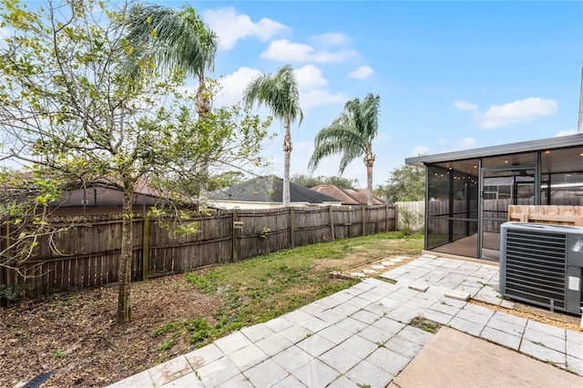 view of patio / terrace with central AC and a sunroom