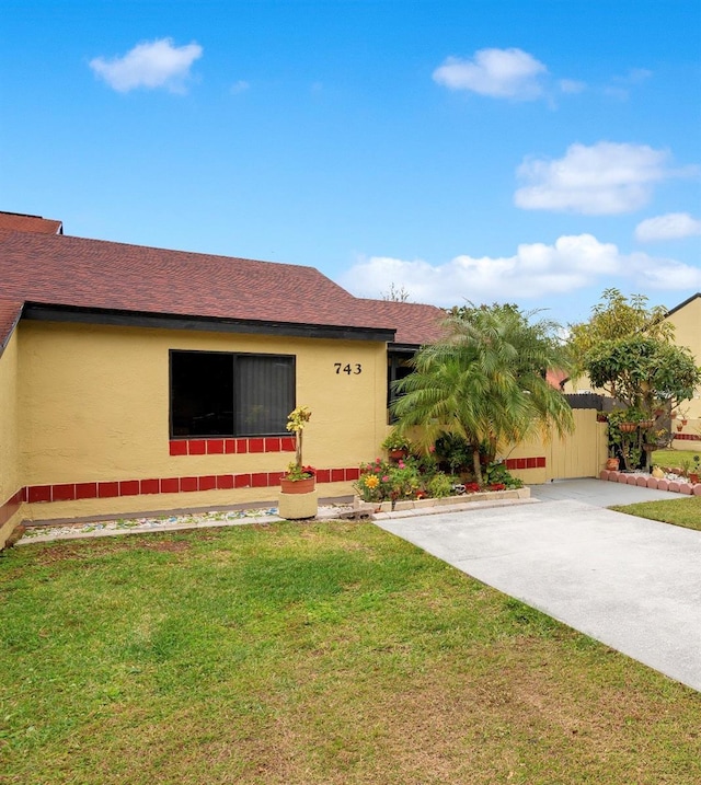 view of side of home featuring a lawn